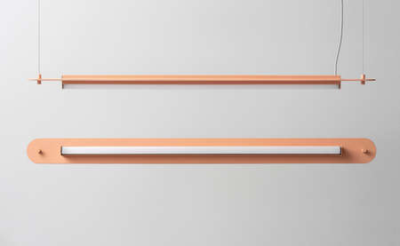 Orange metal lamps hanging on gray wall background in studioの写真素材