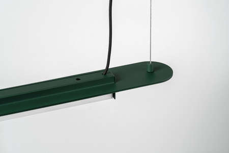 Dark green metal lamp hanging on gray wall background in studioの写真素材