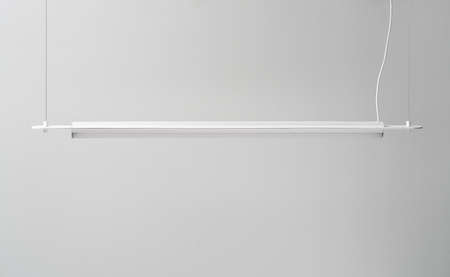 White metal lamp hanging on gray wall background in studioの写真素材