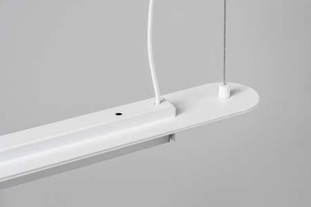 White metal lamp hanging on gray wall background in studioの写真素材