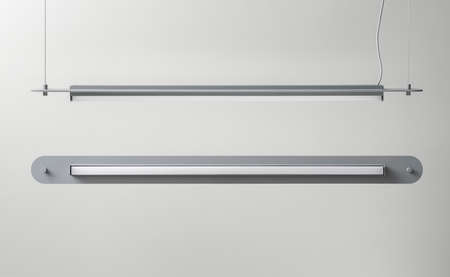 Gray metal lamps hanging on light wall background in studioの写真素材
