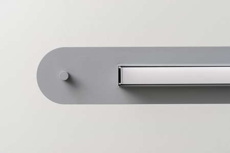 Gray metal lamp on light wall background in studioの写真素材