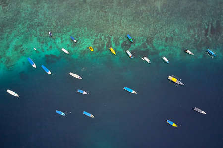 Top view at fishing boats in tropical sea in Indonesiaの写真素材