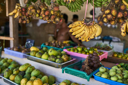 Exotic street market with many colorful tropical fruitの写真素材