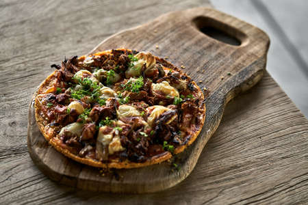 Cooked Jackfruit vegetarian pizza on wooden boardの写真素材