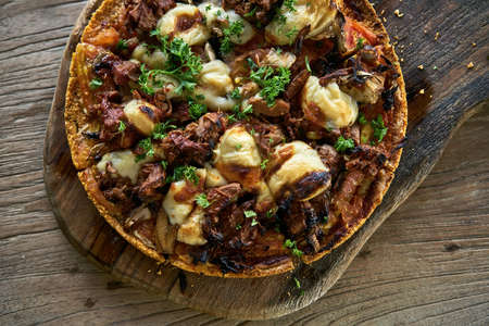 Cooked Jackfruit vegetarian pizza on wooden boardの写真素材