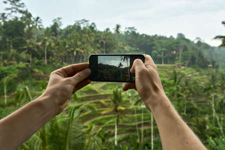 Man shooting photo on terraced rice fields background on Baliの写真素材