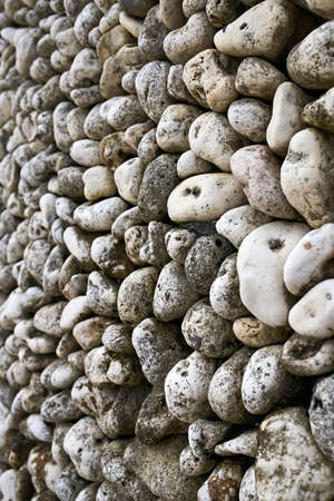 Wall background made of natural texture pebblesの写真素材