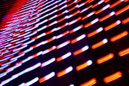 Long exposure photo of moving colorful neon light patternsの写真素材