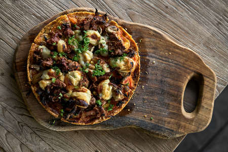 Cooked Jackfruit vegetarian pizza on wooden boardの写真素材