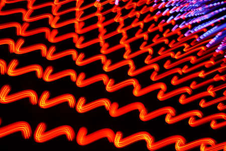Long exposure photo of moving colorful neon light patternsの写真素材