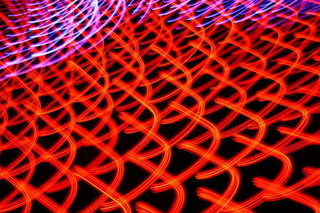 Long exposure photo of moving colorful neon light patternsの写真素材