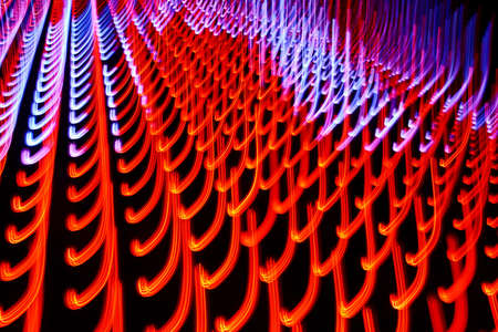 Long exposure photo of moving colorful neon light patternsの写真素材