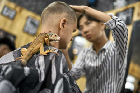 Man is cutting his hair in asian barbershopの写真素材