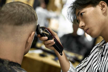 Man is cutting his hair in asian barbershopの写真素材