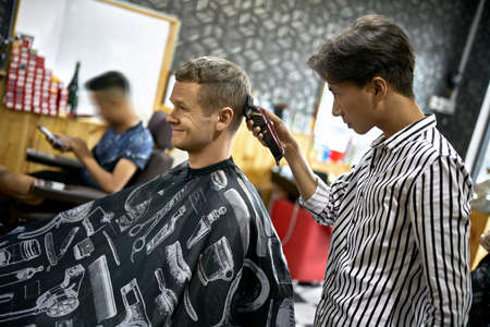 Man is cutting his hair in asian barbershopの写真素材
