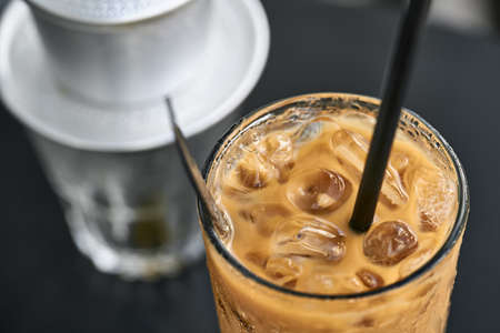 Macro photo of iced coffee drink on black table outdoorsの写真素材