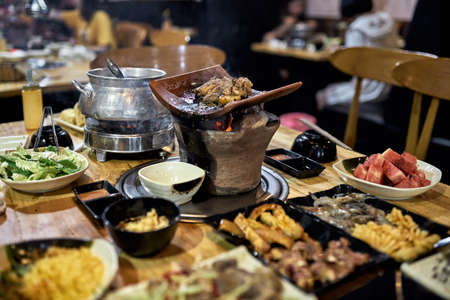Traditional vietnamese hot spot restaurant with varied foodの写真素材