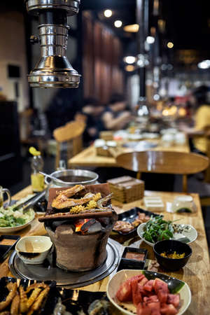 Traditional vietnamese hot spot restaurant with varied foodの写真素材