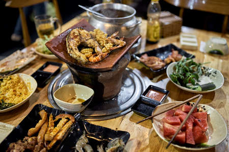 Traditional vietnamese hot spot restaurant with varied foodの写真素材