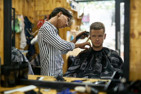 Man is cutting his hair in asian barbershopの写真素材
