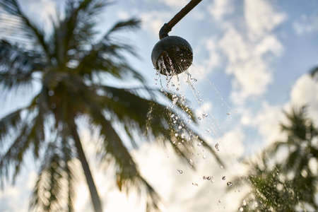 Beach shower with flowing water on old metal pipeの写真素材