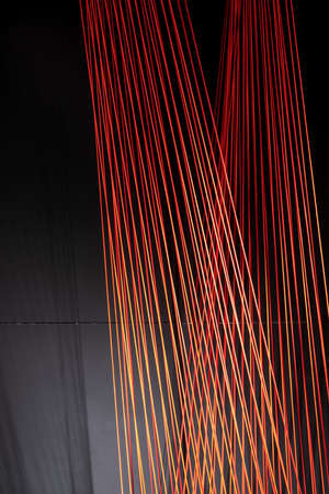Multicolored ropes lines installation in illuminated interiorの写真素材