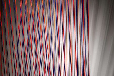 Multicolored ropes lines installation in illuminated interiorの写真素材