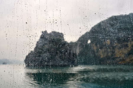 View through window at blurred landscape of sea bay of Halongの写真素材