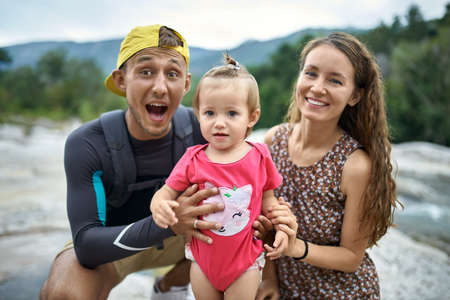 Parents with their little child posing outdoorsの写真素材