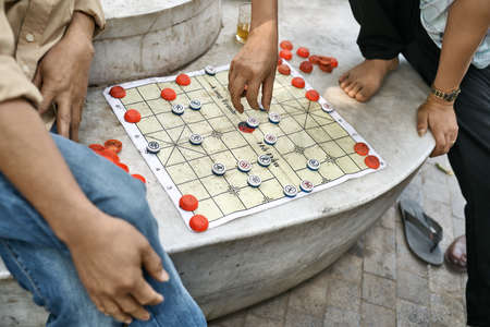 Gamers playing traditional asian chess outdoors in Hanoiの写真素材
