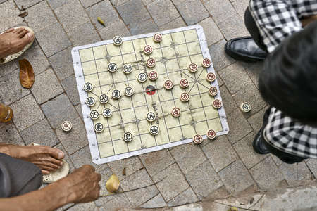 Gamers playing traditional asian chess outdoors in Hanoiの写真素材