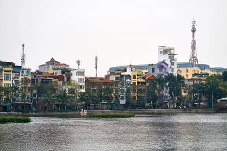 Colorful houses with cell towers on quay in Hanoiの写真素材