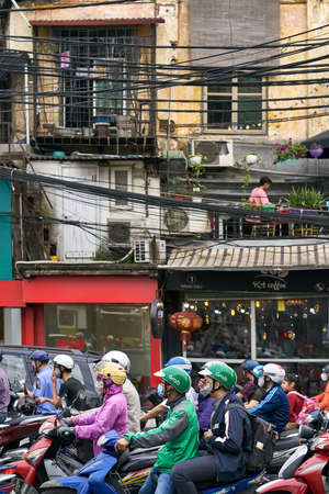 Busy city street with motor bikers in Hanoi