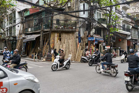 Busy city street with motor bikers in Hanoiのeditorial素材