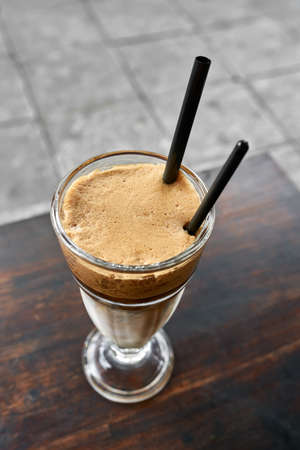 Refreshment iced coffee drink on table outdoorsの写真素材
