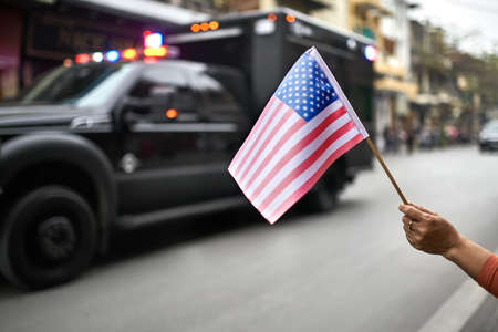 Citizen with flag welcomes diplomatic escort car passageの写真素材