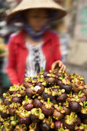 Exotic mangosteens on asian street market in Vietnamの写真素材