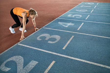 Athletic blonde woman training at indoor stadiumの写真素材