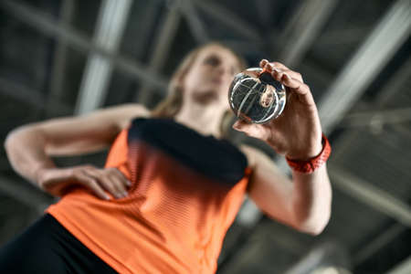 Sportive blonde woman posing at indoor stadiumの写真素材