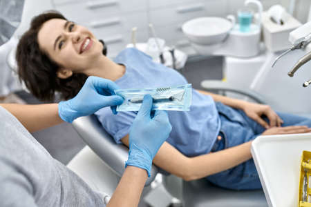 Pretty womans teeth treatment in dental clinicの写真素材
