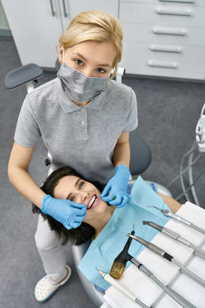 Pretty womans teeth cleaning in dental clinicの写真素材