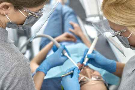 Pretty womans teeth treatment in dental clinicの写真素材