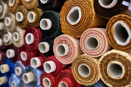 Fabric warehouse with many multicolored textile rollsの写真素材