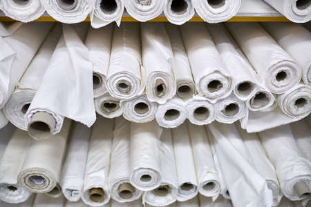 Fabric warehouse with many multicolored textile rolls