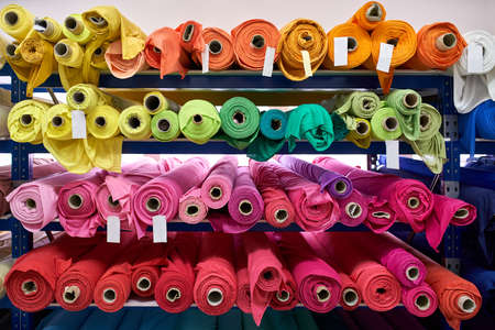 Fabric warehouse with many multicolored textile rollsの写真素材
