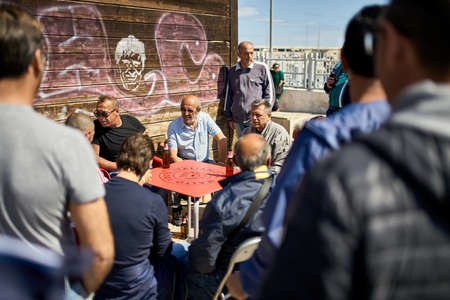 Italian men playing cards on sunny street