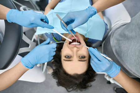 Pretty womans teeth treatment in dental clinic