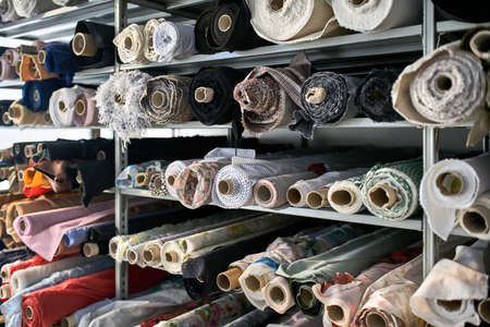 Fabric warehouse with many multicolored textile rollsの写真素材