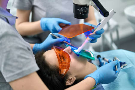 Pretty womans teeth treatment in dental clinicの写真素材